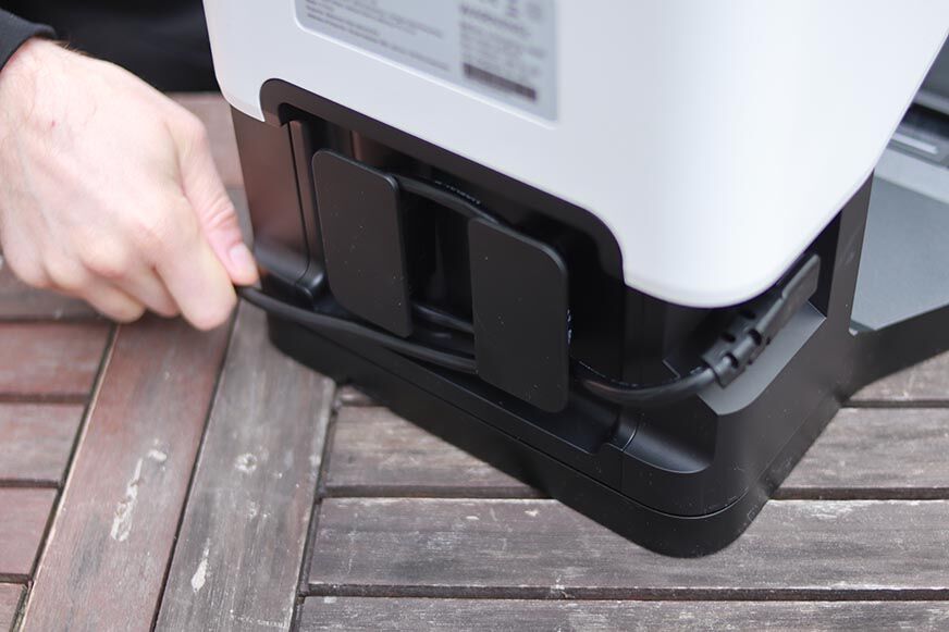 The power cable from the Roborock Q7 Max+ emptying station is rolled up.